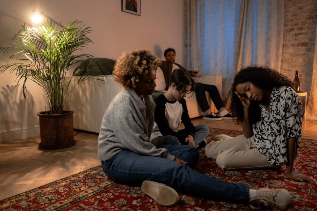 A family sitting on the floor having problems