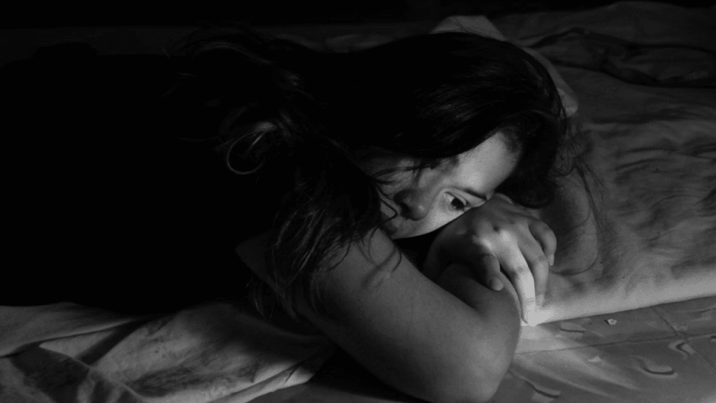 A woman looking sad at home