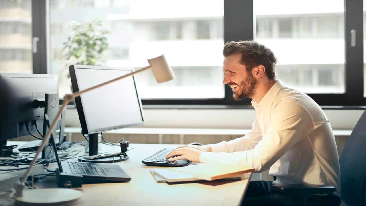 A man laughing in the office 