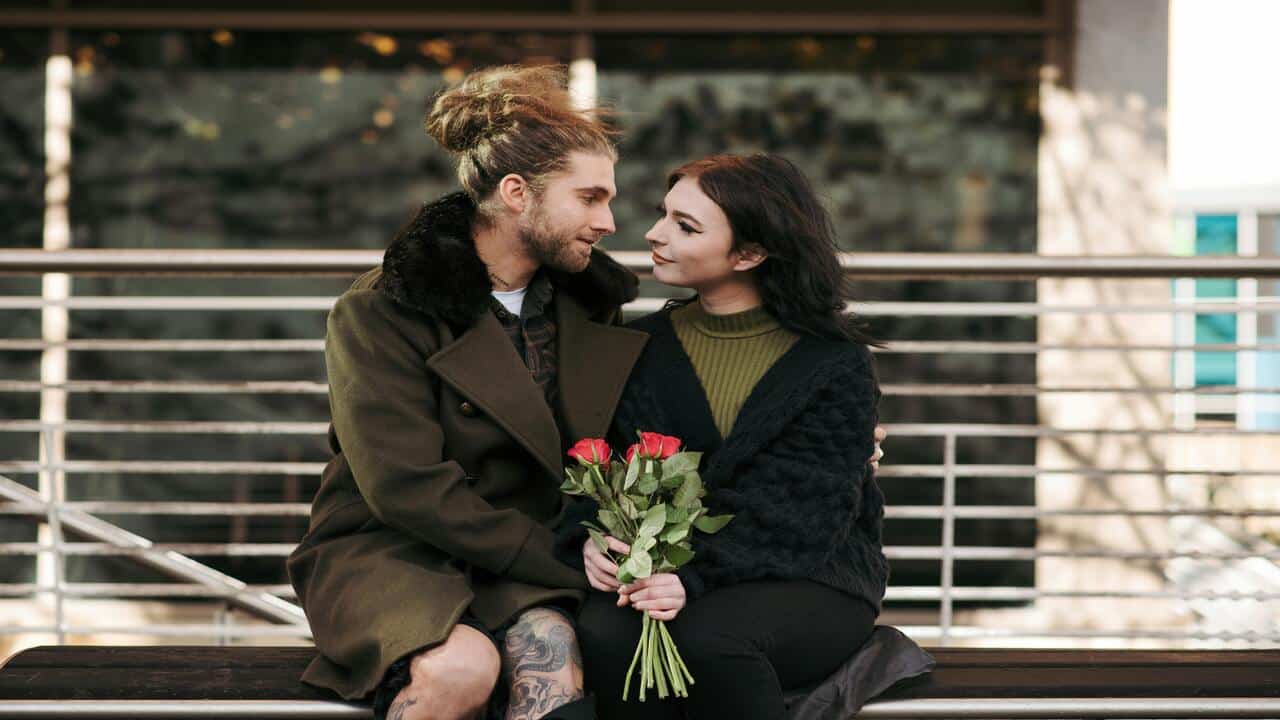 A man giving his girlfriend roses