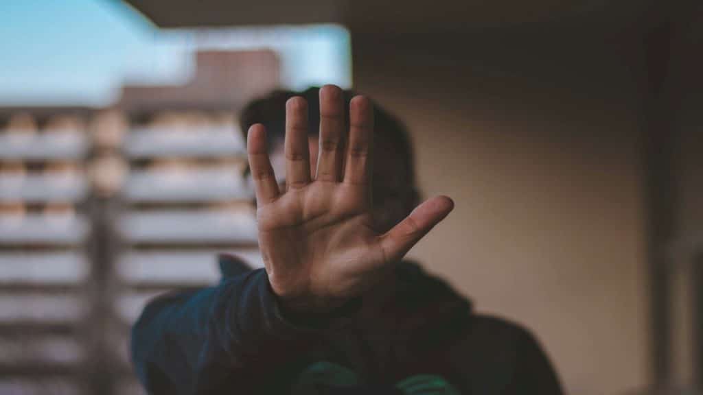 A man saying no using his hand