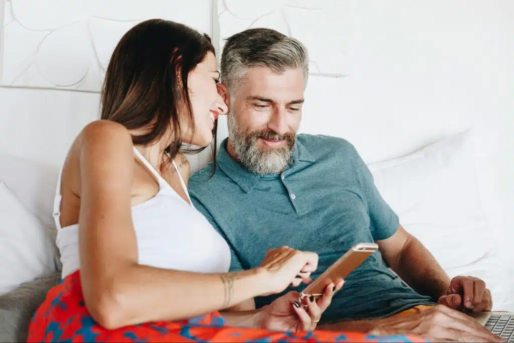 A man and woman looking at the tablet