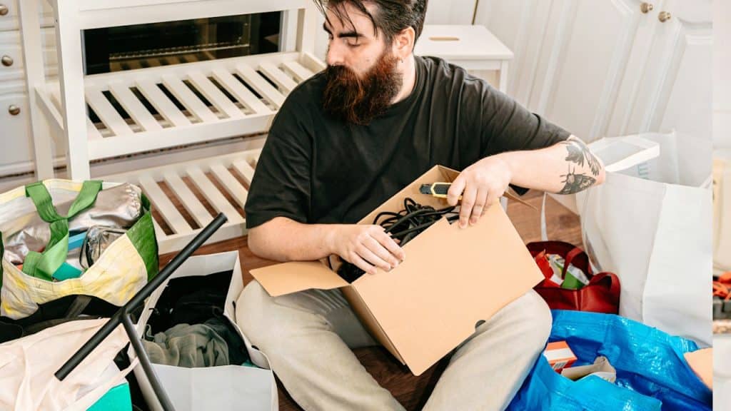 A man sorting for boxes while shifting.