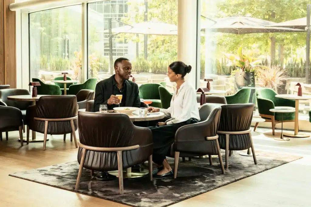 A man and a woman sitting at a table in the café.