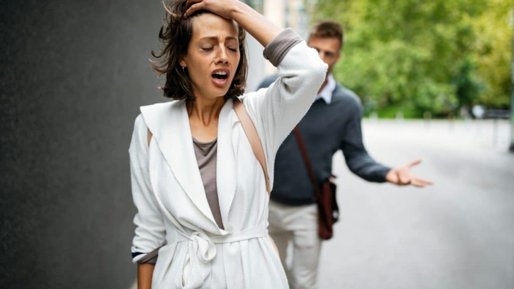 Frustrated couple having marriage problems is arguing outdoors.