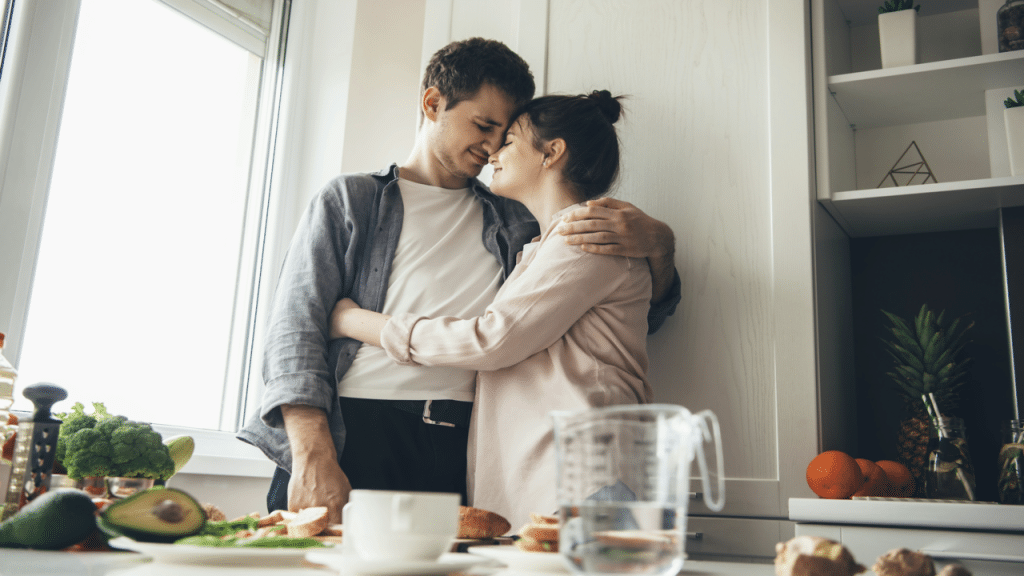 A couple hugging in the kitchen