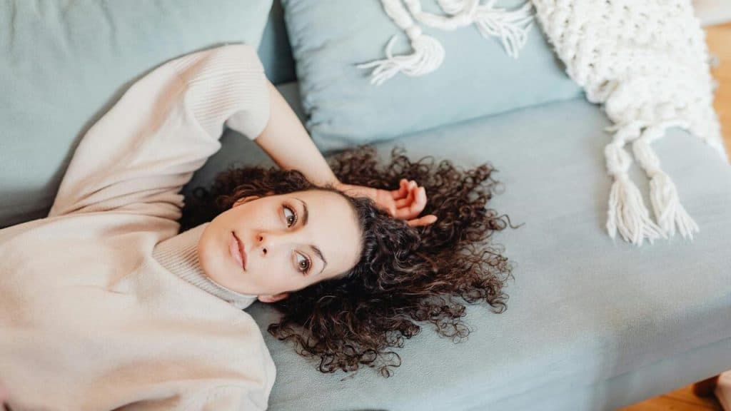 A woman looking tired at home