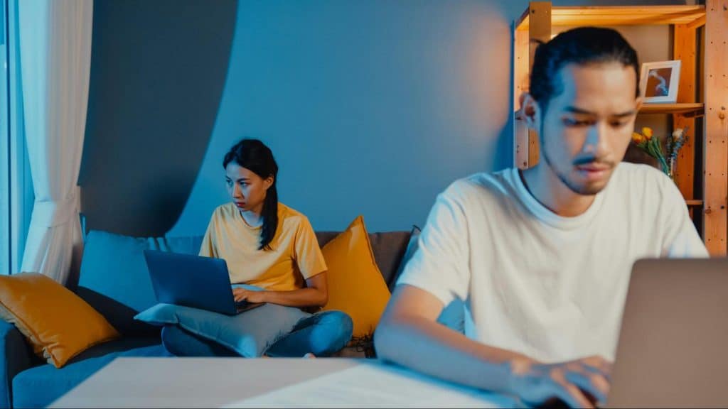 A man and woman looking at the computer
