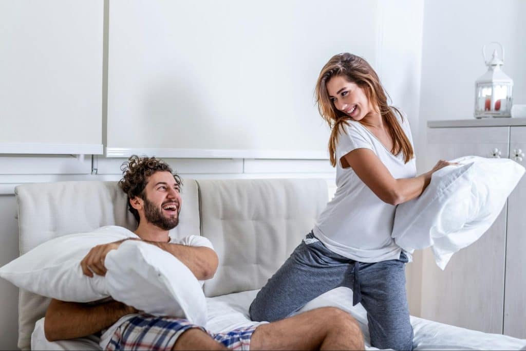 A man and woman at the bed