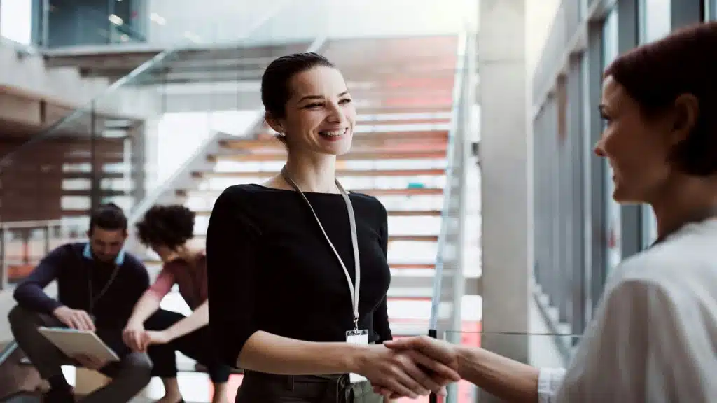 Two colleagues shaking hands at work