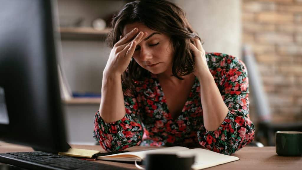 A woman looking disappointed at home