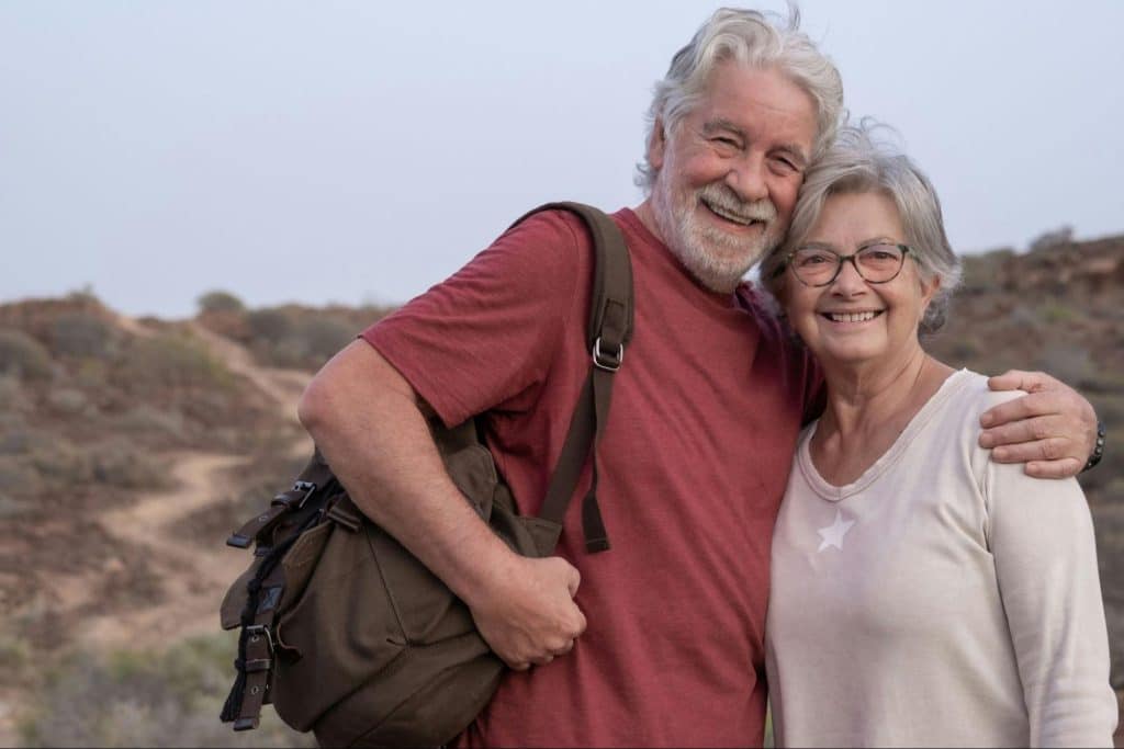 A man and woman smiling at the camera