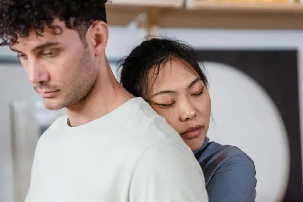 A woman hugging a man