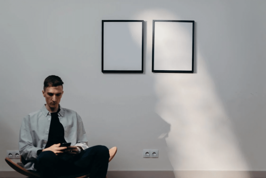 Man in Gray Dress Shirt Sitting on Yellow Chair