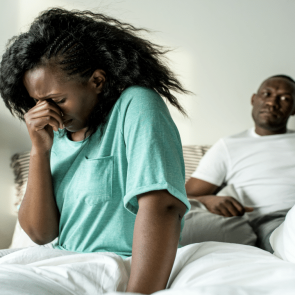 A couple looking upset in the bedroom