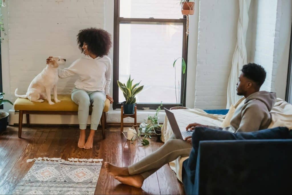 A man looking at the woman petting the dog