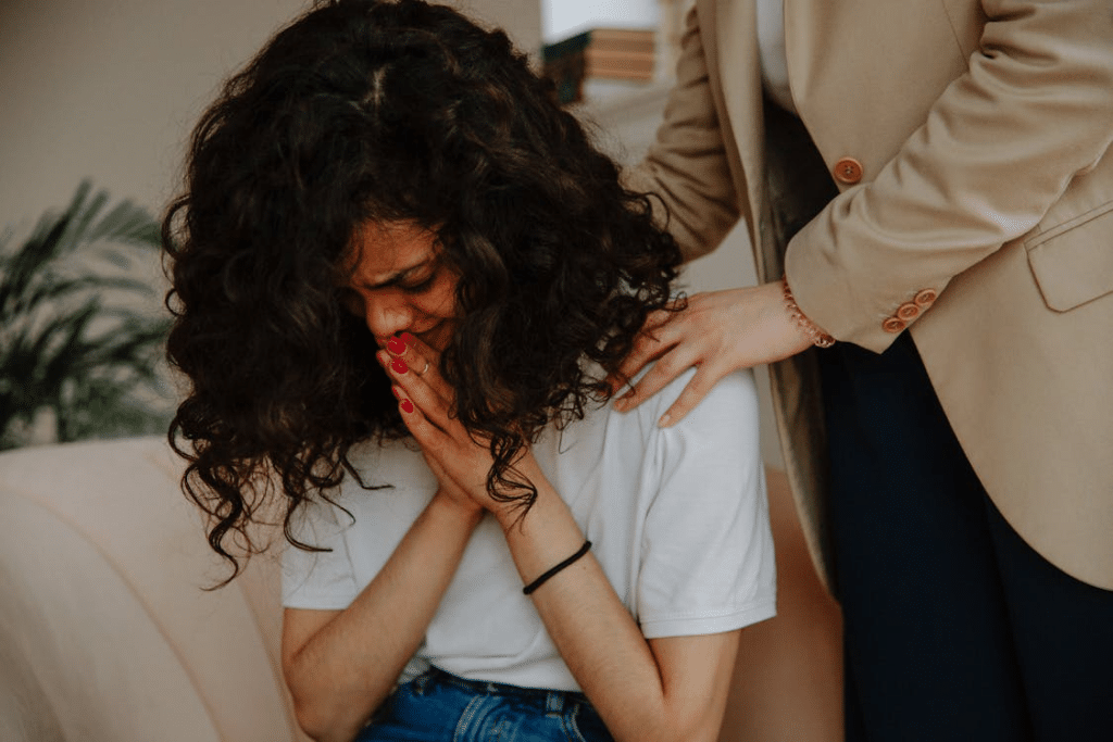 A therapist comforting a patient