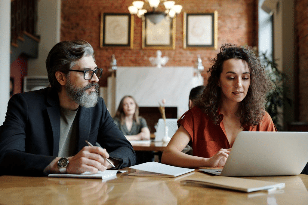 A man taking notes beside a woman