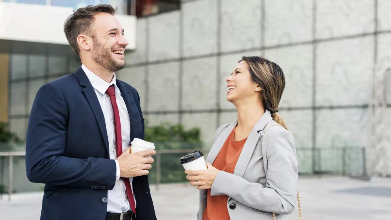 Colleagues laughing outdoors 