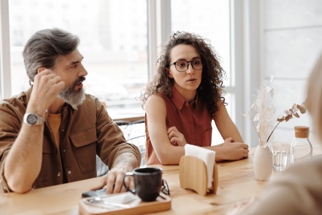 A man and a woman talking at a table