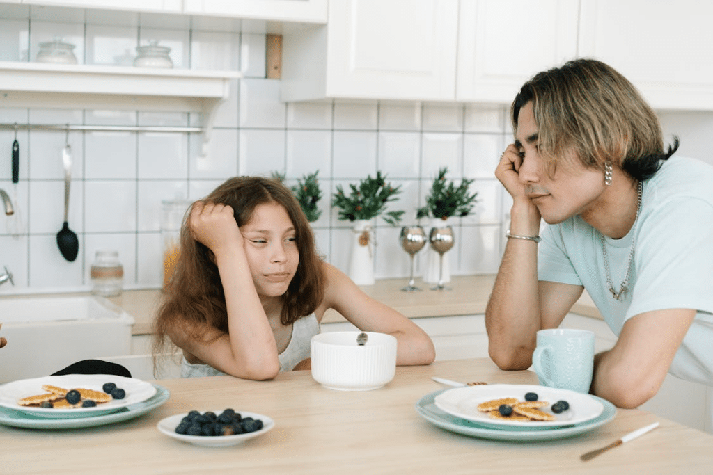 A Man in White Shirt Looking at His Daughter