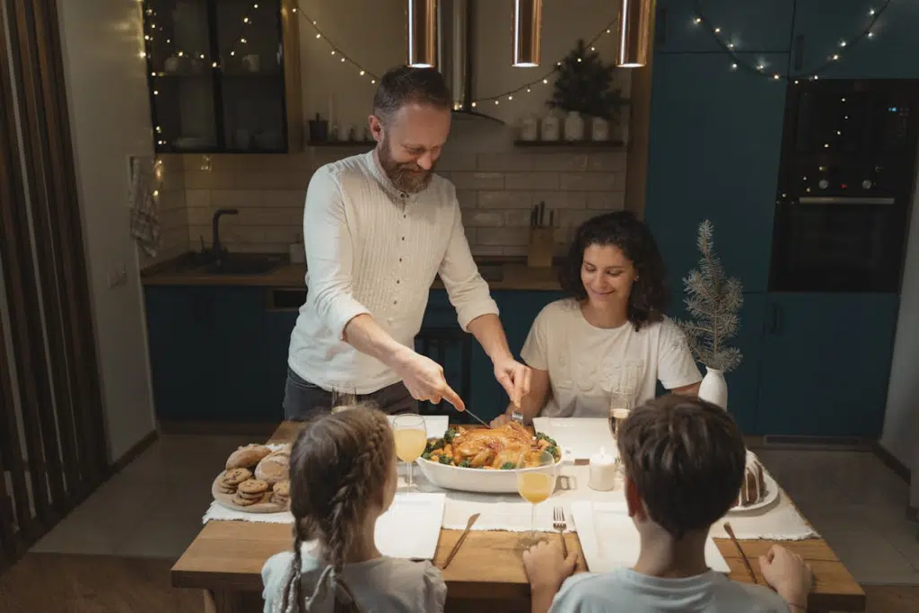 A father cutting a roasted turkey