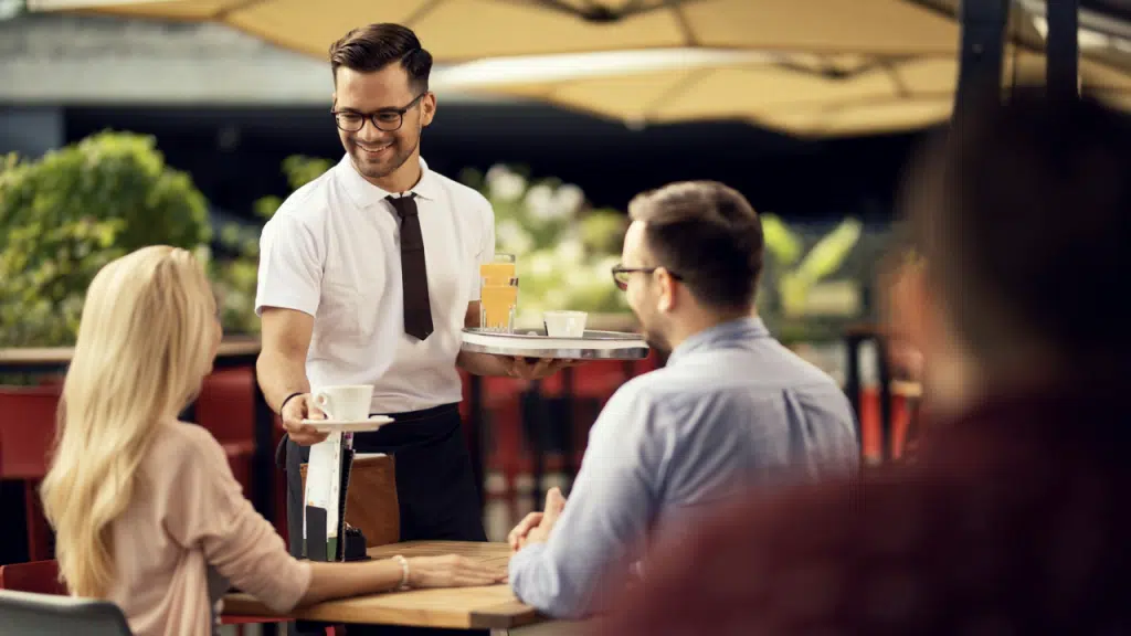 A couple talking to a waiter