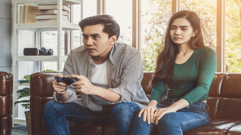 A man ignoring his girlfriend to play video games