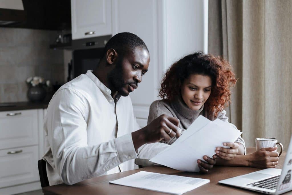 A man and woman checking document