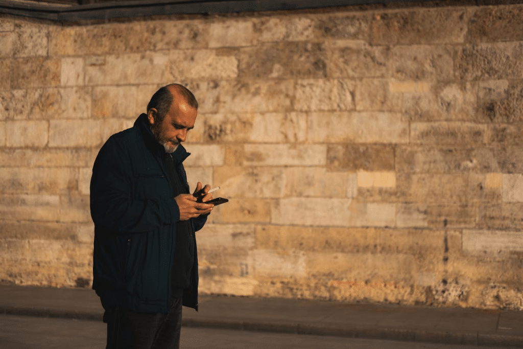 Smoking Man Using Smartphone