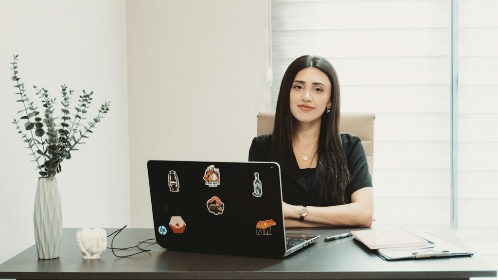 A woman sitting at a table and using her laptop.
