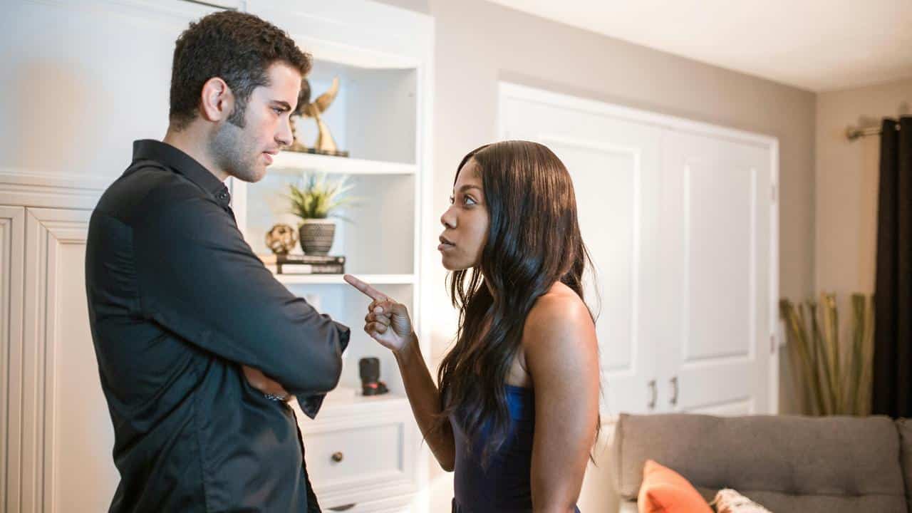 A couple arguing with each other as the woman points her finger at the man.