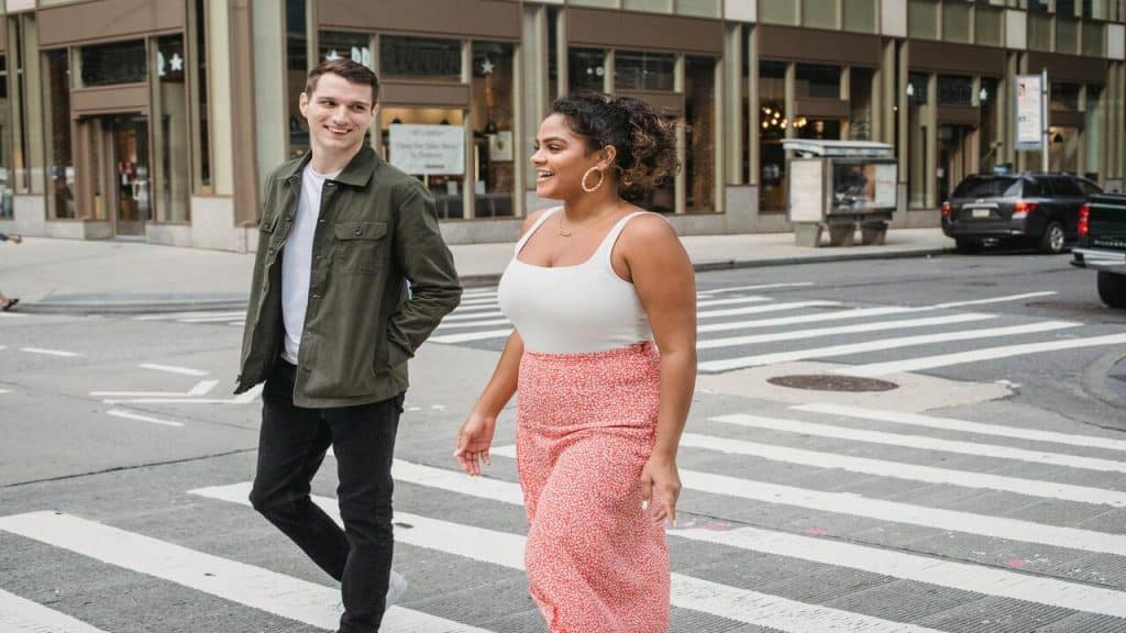 A couple crossing the road together 