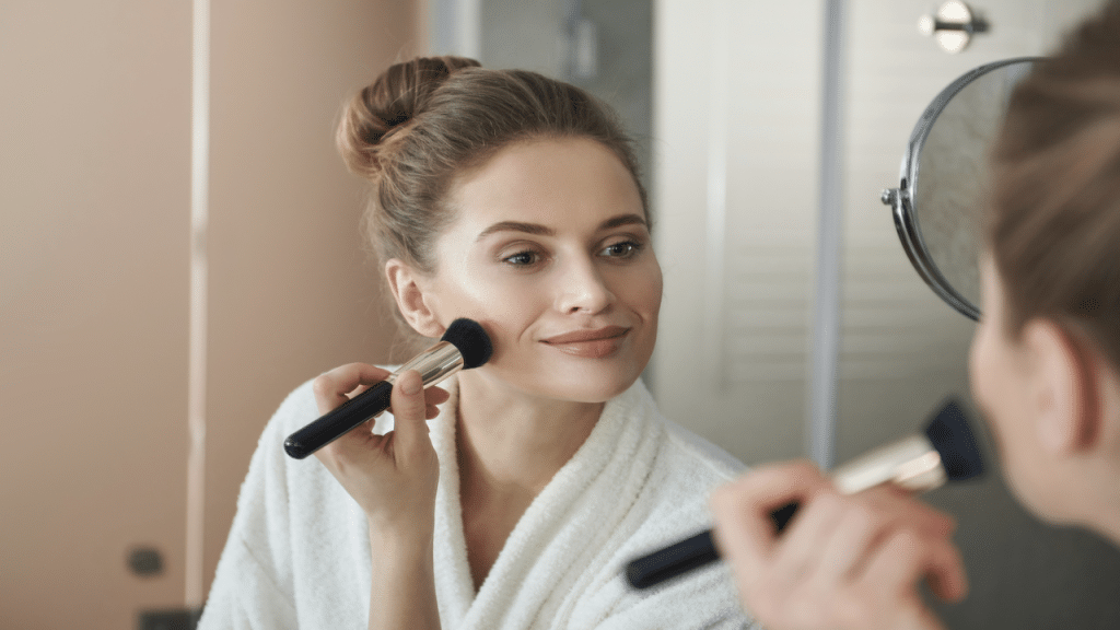 A woman putting on makeup