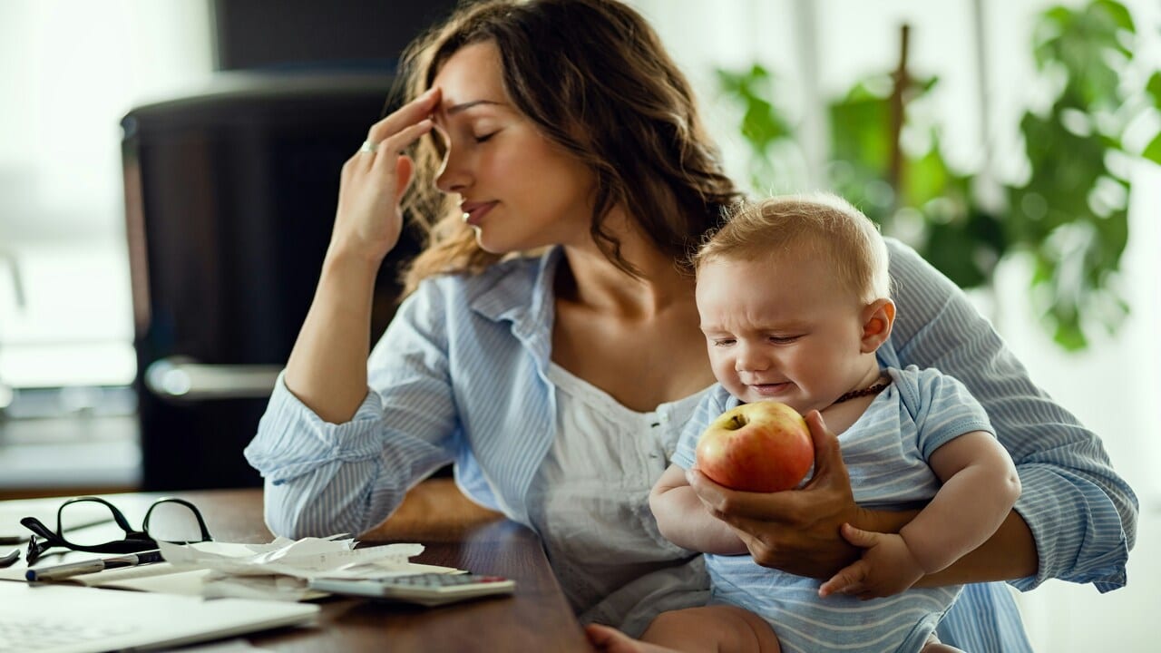 A mom looking stressed while working from home