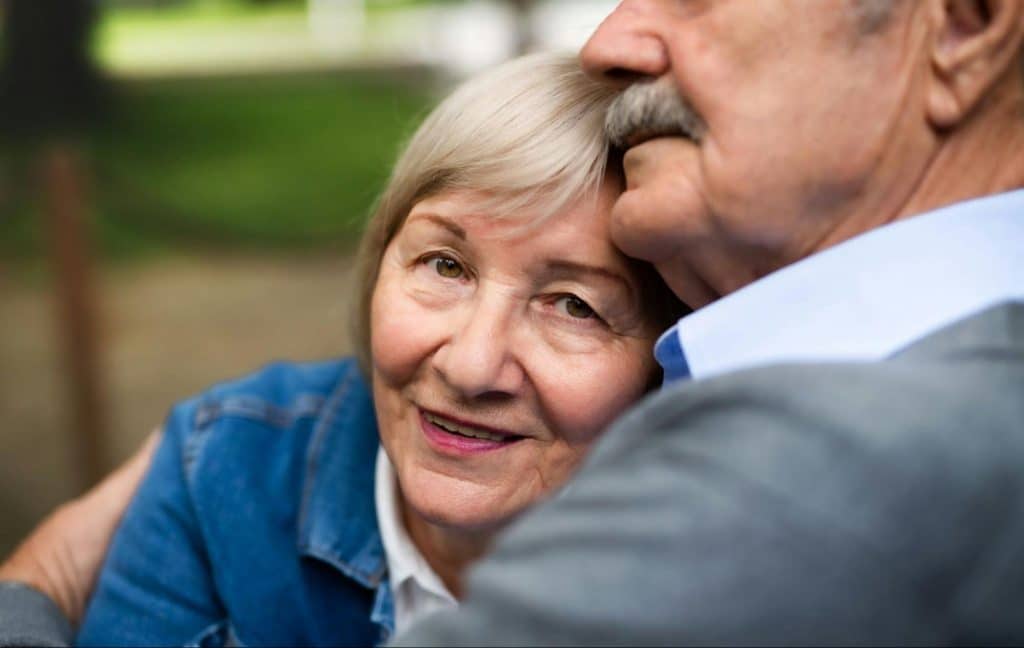 A man hugging a woman