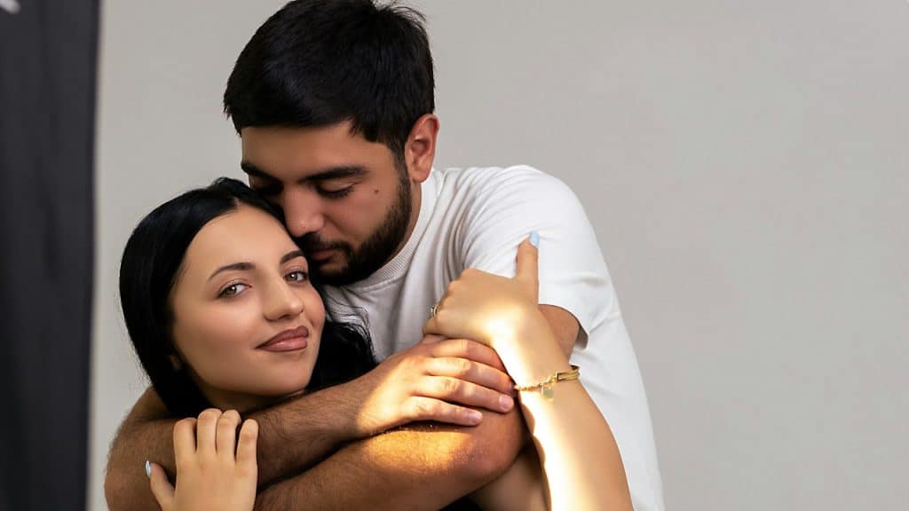 A couple embracing each other affectionately.