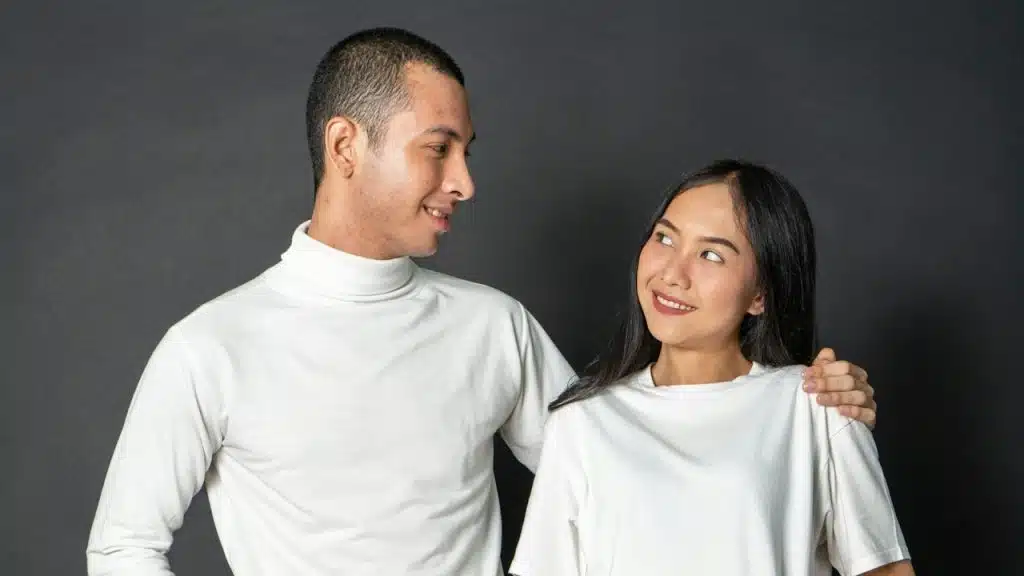 A man and a woman standing next to each other and smiling.