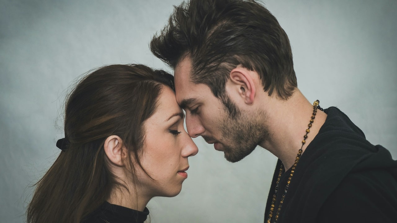 A couple touching foreheads and having a tender moment.