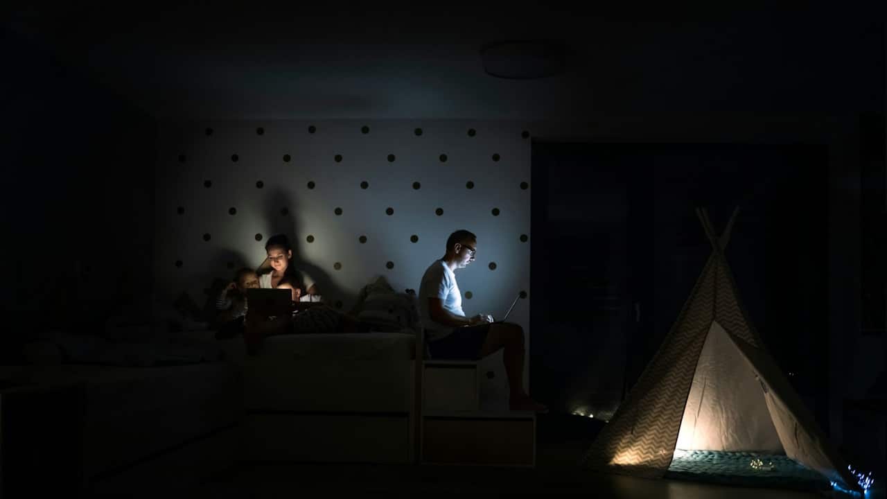 A couple working separately in their room.