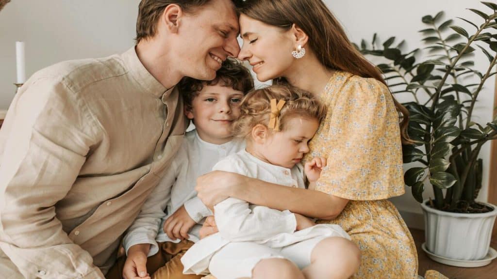 A couple forehead to forehead with their kids