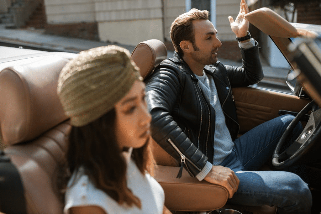 Man in Black Leather Jacket Sitting Beside Woman Having An Argument