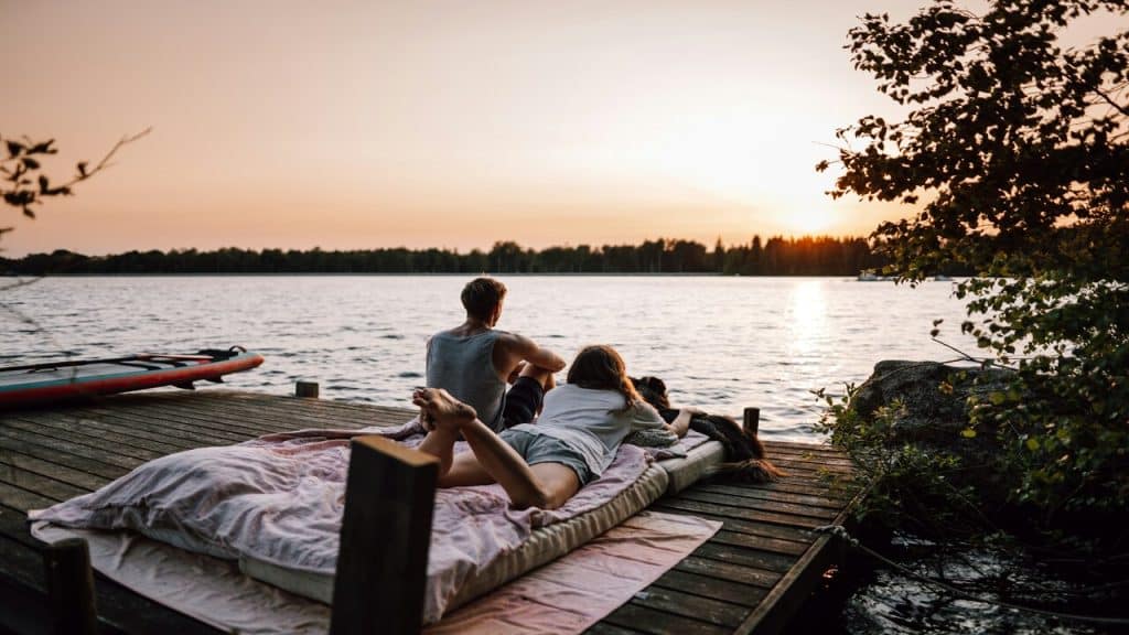A couple watching the sunset on a dock