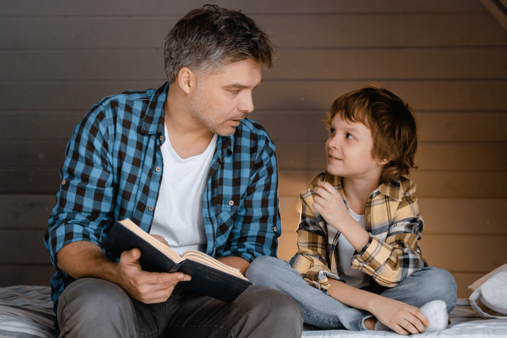 Man in Plaid Shirt Sitting Beside a Boy
