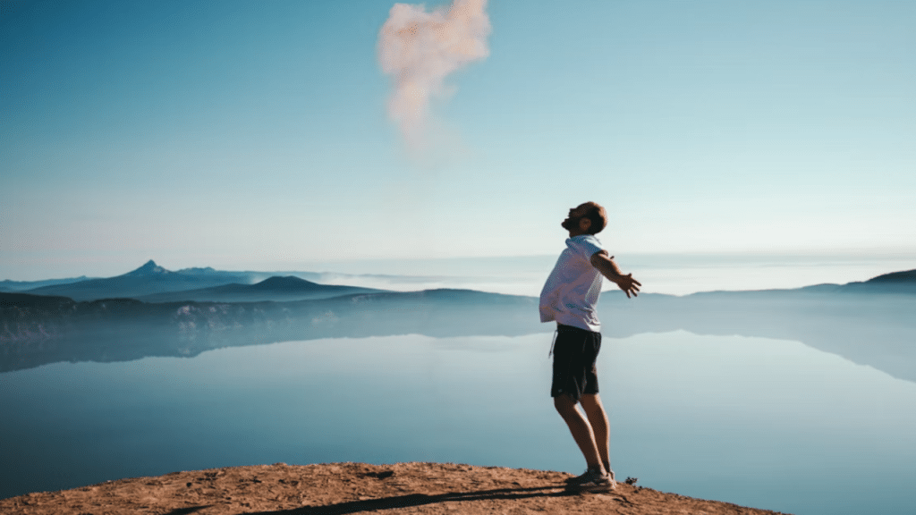 A man looking happy by a lake