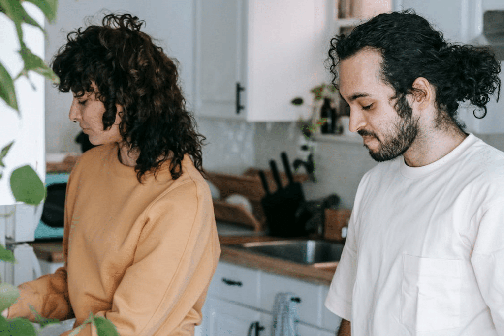 A Couple Standing In The Kitchen