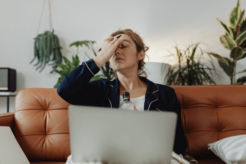 A stressed woman using a laptop