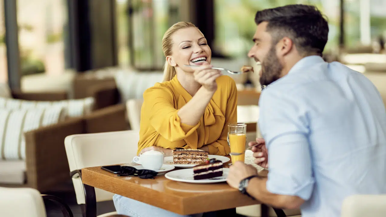 A woman trying to feed her date 