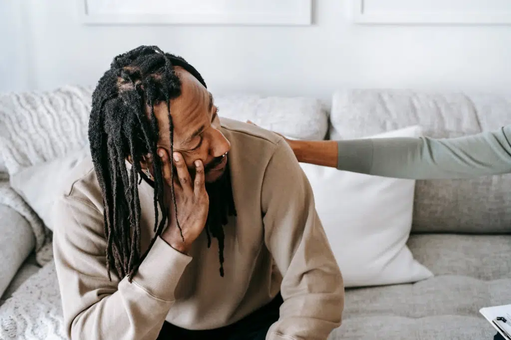 A frustrated man sitting on a sofa
