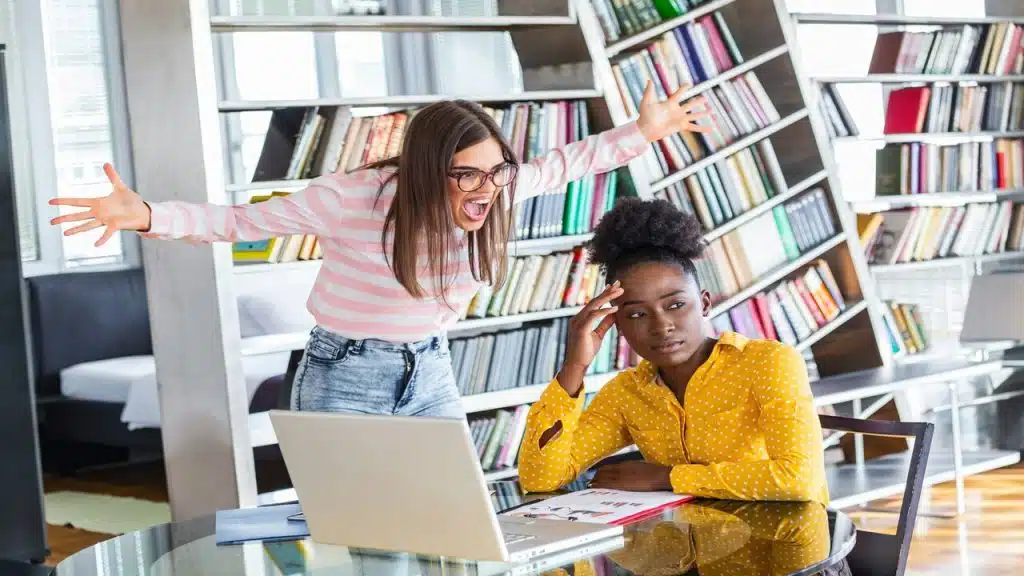 A woman ignoring a colleague who’s yelling at her
